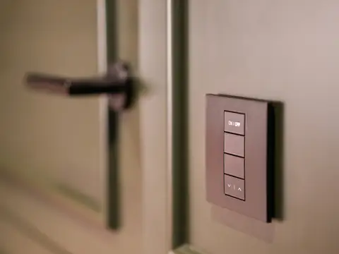 A modern smart light switch panel on a wall